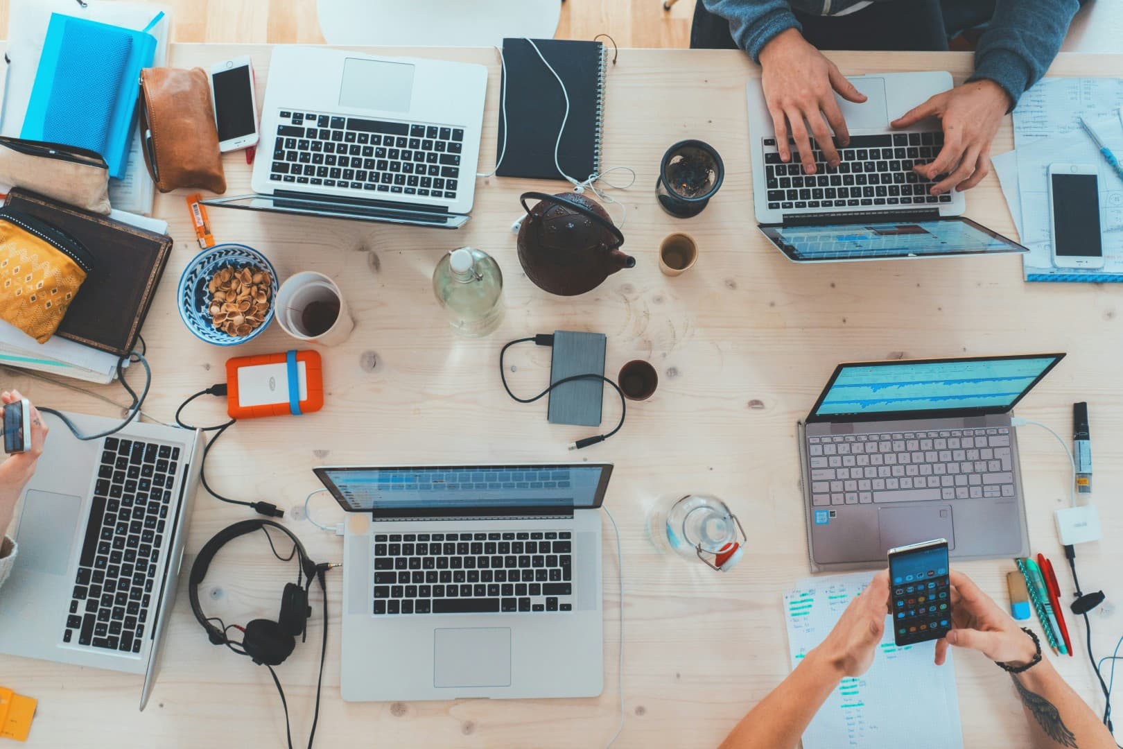 Team brainstorming session with laptops on a collaborative workspace desk